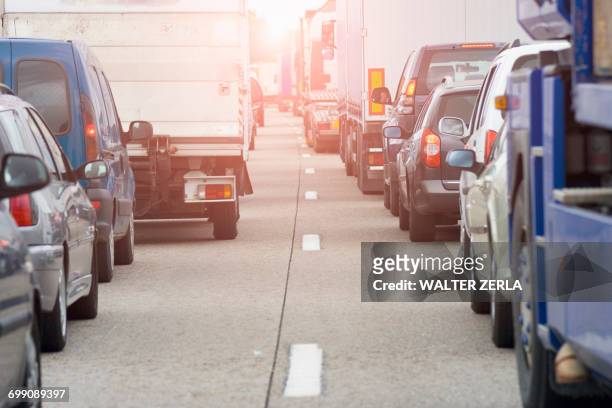 rear view of rows of traffic queueing on highway - file stockfoto's en -beelden