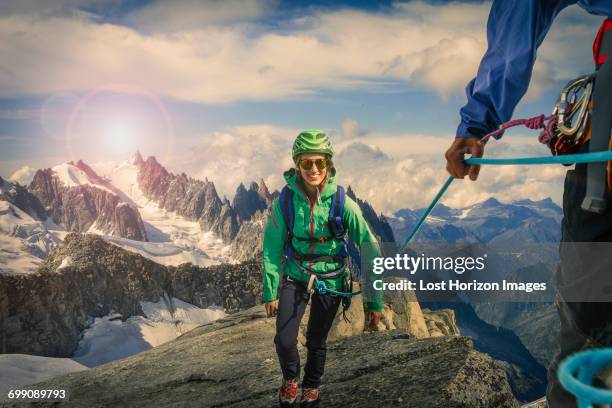 climbing couple climbing ridge at mont savoie, france - mont blanc massiv stock-fotos und bilder
