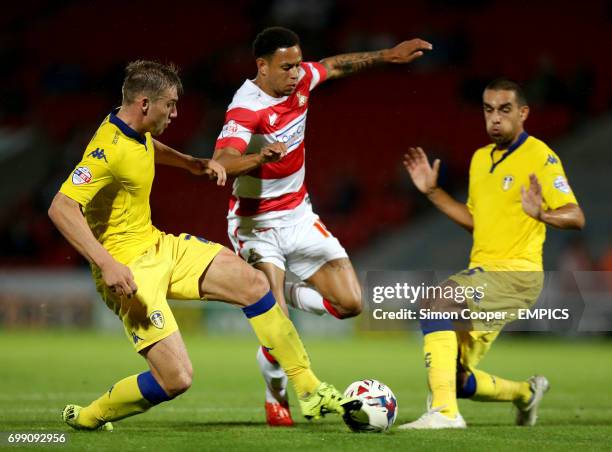 Doncaster Rovers' Nathan Tyson takes on Leeds United's Giuseppe Bellusci and Charlie Taylor