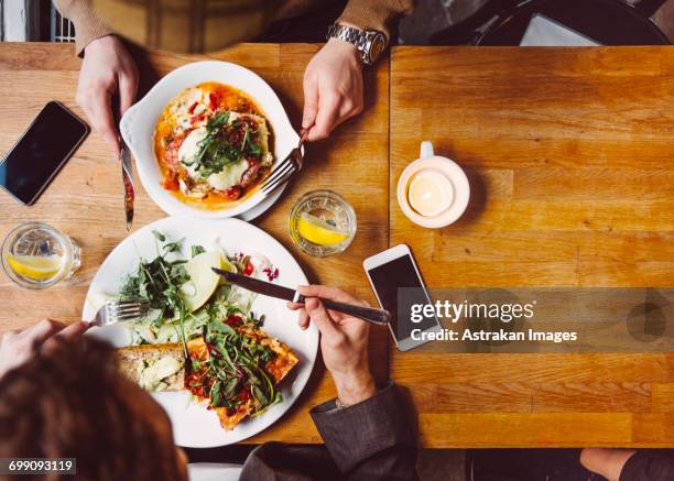 sweden, stockholm, gamla stan, two men having lunch - fika stock pictures, royalty-free photos & images