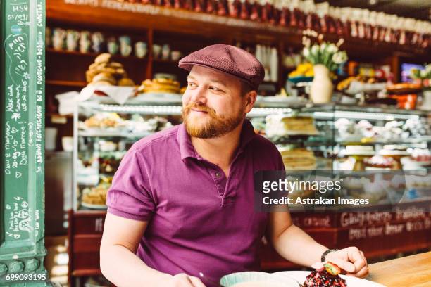 sweden, stockholm, gamla stan, man having dessert in cafe - fika stock pictures, royalty-free photos & images