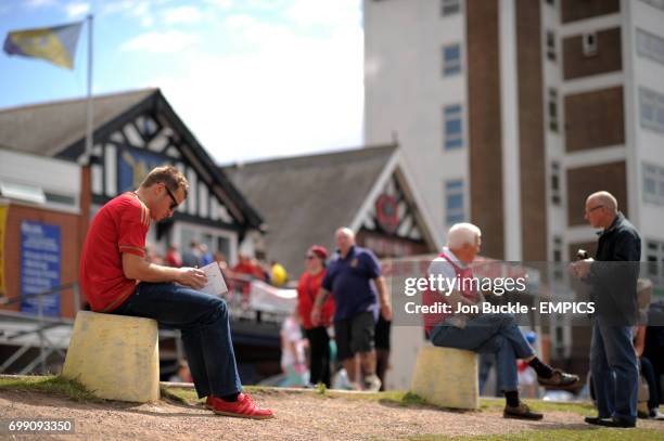 Fans relax on the banks of The River Trent prior to kick off