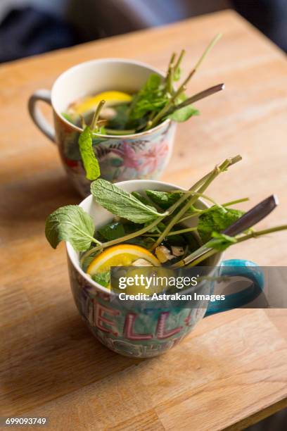 sweden, stockholm, gamla stan, two cups with leaves and lemon slices - fika stock pictures, royalty-free photos & images