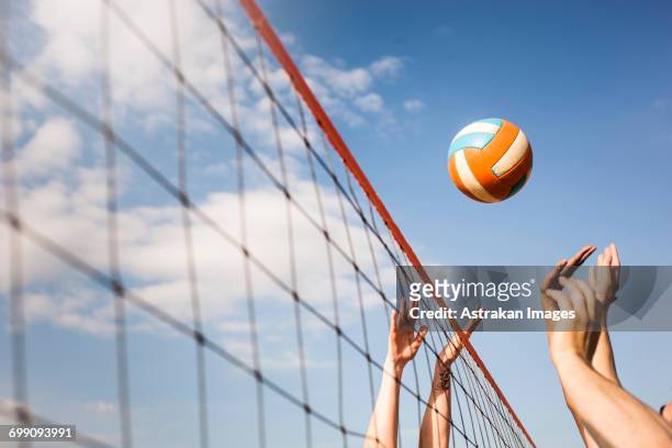 cropped image of people volleyball at beach - beachvolleyball stock pictures, royalty-free photos & images