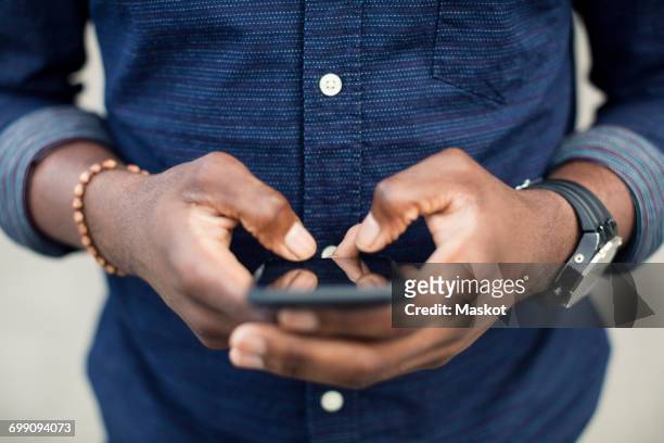 midsection of man using mobile phone - telefon sms bildbanksfoton och bilder