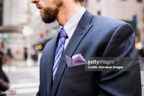 midsection of well-dressed businessman standing on city street - pocket ストックフォトと画像