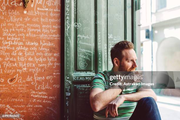 sweden, stockholm, gamla stan, man holding coffee cup in cafe - fika stock pictures, royalty-free photos & images