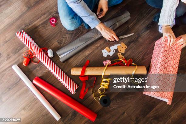 cropped image of man and woman wrapping gifts at home - national day celebrations in sweden 2016 imagens e fotografias de stock