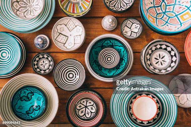 directly above shot of multi colored bowls on wooden table - tableware stock pictures, royalty-free photos & images