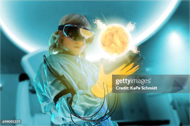 boy in virtual reality headset interacting with digital floating sun - virtual reality kids stock pictures, royalty-free photos & images