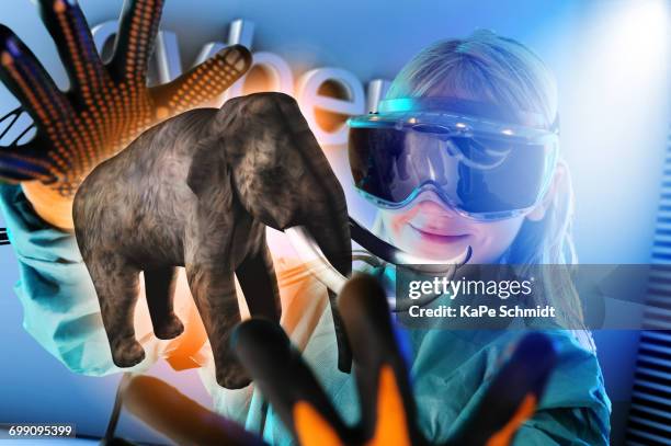 girl in virtual reality headset interacting with digital floating elephant - augmented reality animal stock-fotos und bilder