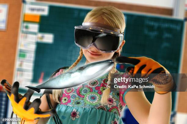 girl pretending to be teacher wearing virtual reality headset and gloves to show whale - virtual reality classroom stock pictures, royalty-free photos & images