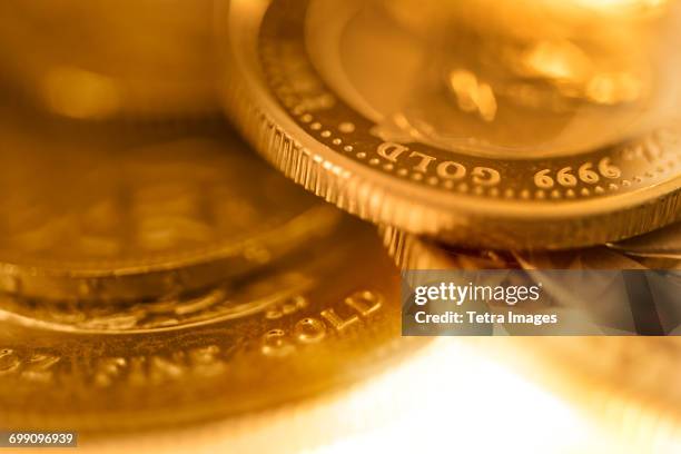 close-up of gold coins - gold coin stock-fotos und bilder