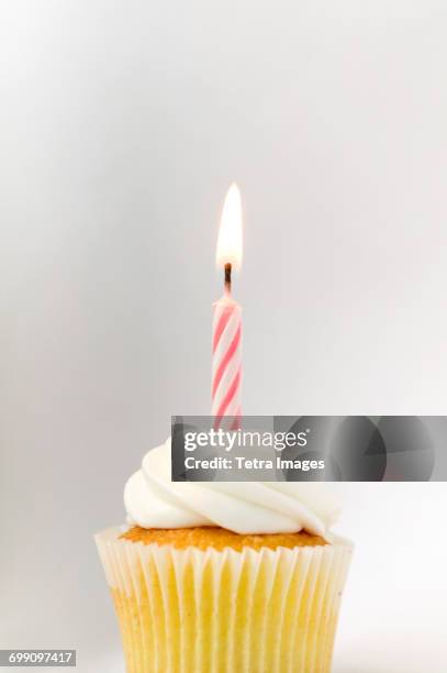cupcake with birthday candle - birthday cupcake stock pictures, royalty-free photos & images