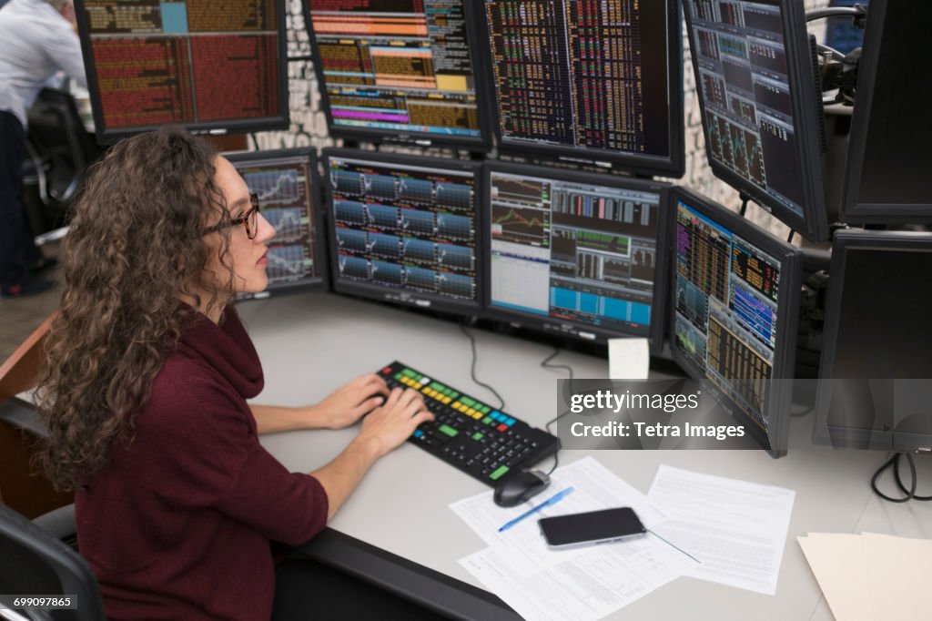 Young trader analyzing computer data