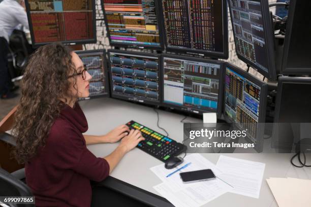 young trader analyzing computer data - wall street lower manhattan stock pictures, royalty-free photos & images