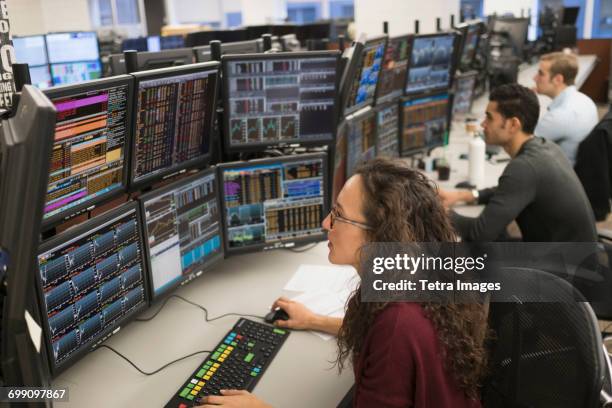 young traders analyzing computer data - wall street imagens e fotografias de stock
