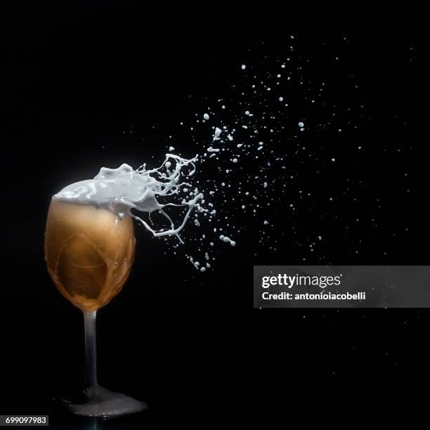 beer foam blowing off a wine glass - spray foam stock pictures, royalty-free photos & images