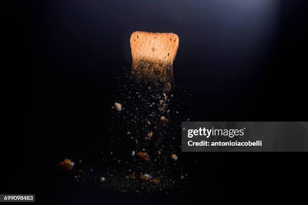 piece of toast with breadcrumbs - disintegration stock-fotos und bilder