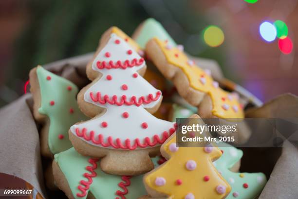 tin of christmas tree cookies - christmas cookies stock pictures, royalty-free photos & images