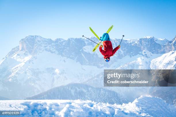 man performing a backflip ski jump, salzburg, austria - achterwaartse salto stockfoto's en -beelden