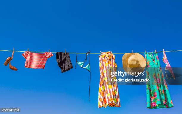 laundry hanging on a washing line - clothesline imagens e fotografias de stock