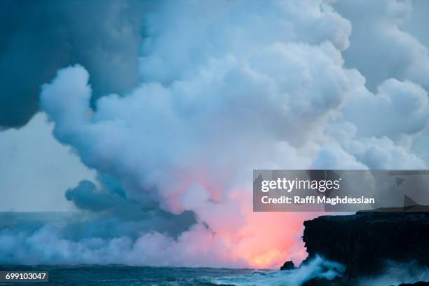 a volcanic eruption over the ocean with lots of billowing smoke - lava ocean stock pictures, royalty-free photos & images