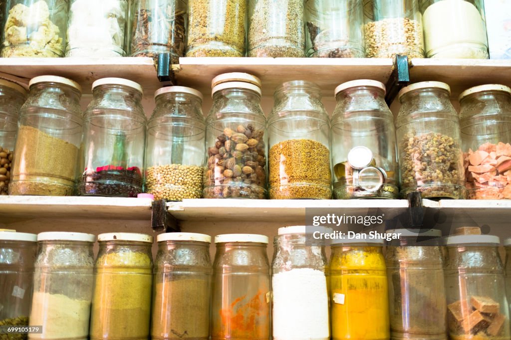 Jars Of Spices And Dried Goods For Sale In A Market Stall