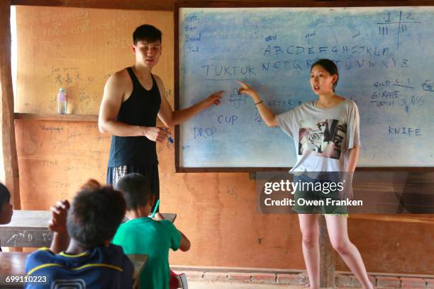 teaching in a rural school in cambodia - charity education stock-fotos und bilder