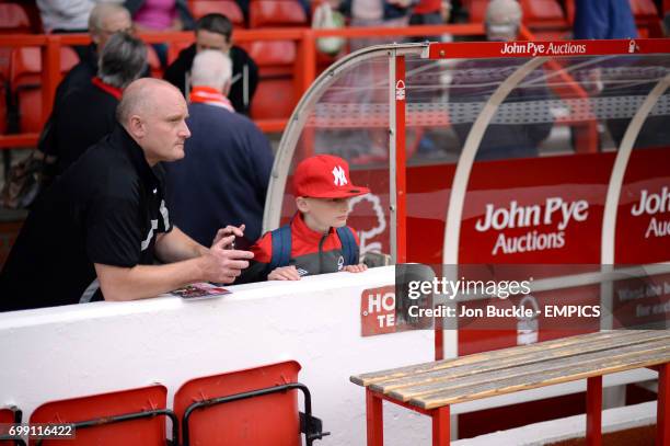 Nottingham Forest fans wait by the home team dugout before the game