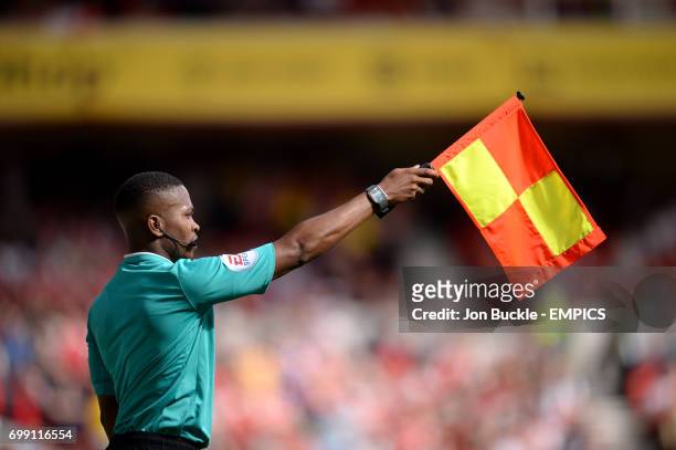 Referee's assistant signals an offside decision