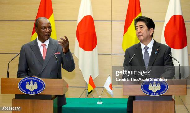 Guinean President Alpha Conde and Japanese Prime Minister Shinzo Abe attend a joint press conference following their meeting at Abe's official...