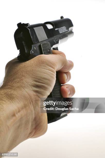 human hand aims the pistol on a white background - gun pov foto e immagini stock