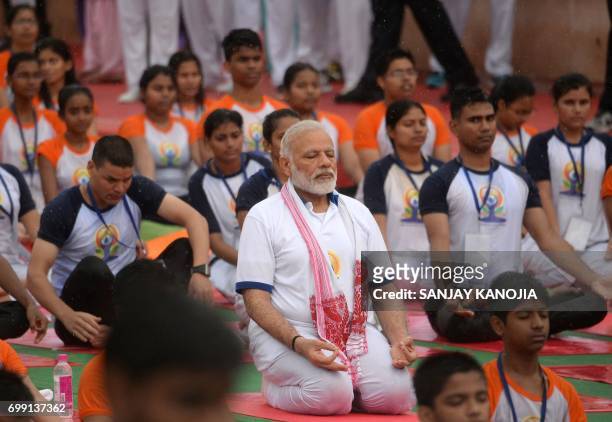 Indian Prime Minister Narendra Modi participates in a mass yoga session along with other Indian yoga practitioners to mark the 3rd International Yoga...
