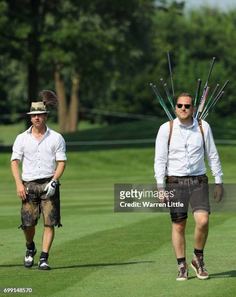 An Bavarian amateur and his caddie compete during the pro-am event ahead of the BMW International Open at Golfclub Munchen Eichenried on June 21,...