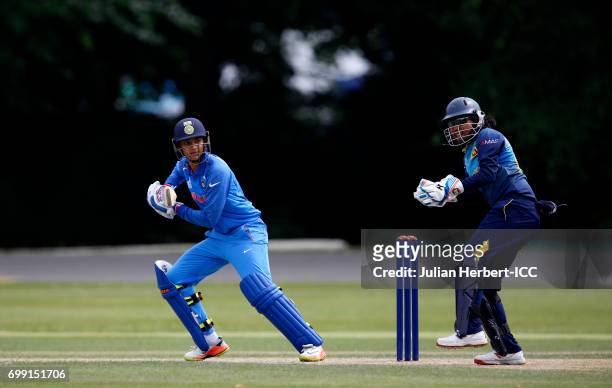 Prassadani Weerakkoodi of Sri Lanka looks on as Smriti Mandhana of India scores runs during The ICC Women's World Cup warm up match between India and...
