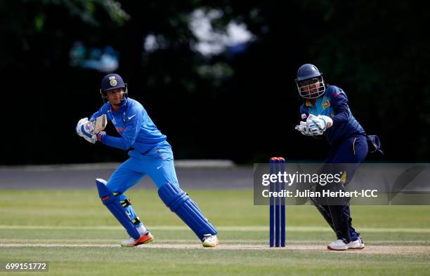 Prassadani Weerakkoodi of Sri Lanka looks on as Smriti Mandhana of India scores runs during The ICC Women's World Cup warm up match between India and...