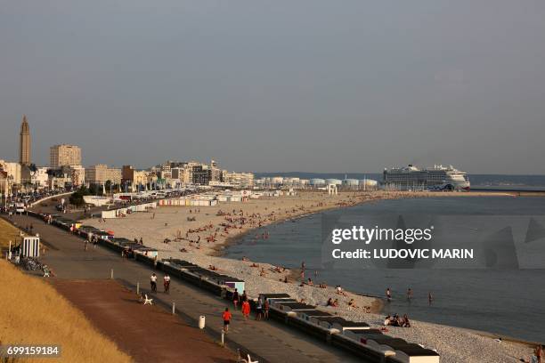 Picture taken on June 20, 2017 in Le Havre shows a view of the beach with the Aida Prima cruise vessel , operated by the German cruise line AIDA...