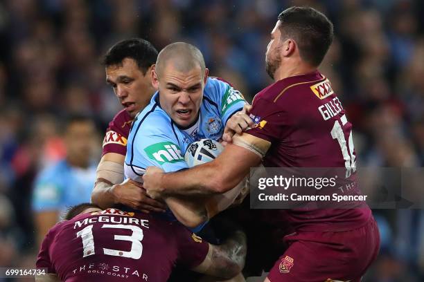 David Klemmer of the Blues is tackled during game two of the State Of Origin series between the New South Wales Blues and the Queensland Maroons at...