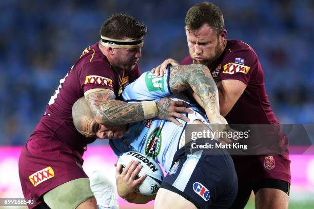 David Klemmer of the Blues is tackled during game two of the State Of Origin series between the New South Wales Blues and the Queensland Maroons at...