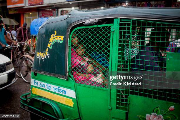 Mother with her daughter stuck in the traffic jam when heavy rainfall made in Dhaka city. The death toll rises to 156 in several hill districts...