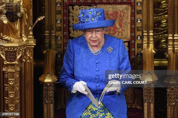 Britain's Queen Elizabeth II delivers the Queen's Speech during the State Opening of Parliament in the Houses of Parliament in London on June 21,...