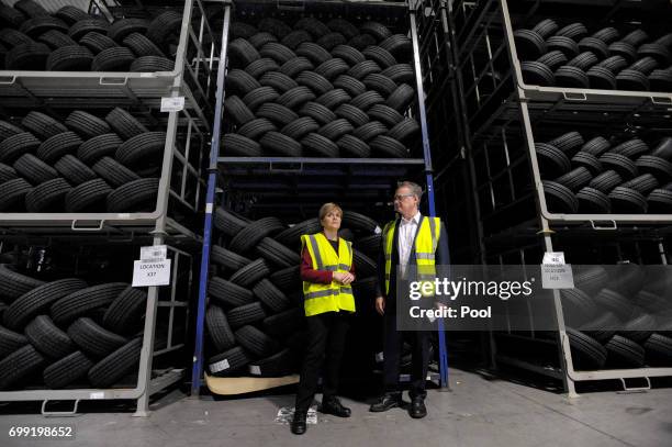 First Minister of Scotland Nicola Sturgeon is shown around by manager John Reid during a visit to the Michelin Tyre factory on June 21, 2017 in...