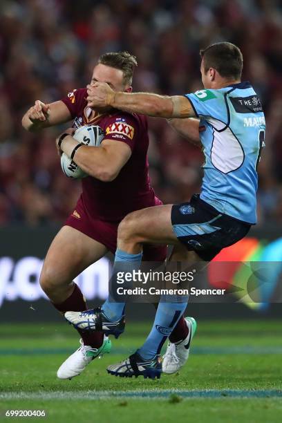 Coen Hess of the Maroons is tackled by James Maloney of the Blues during game two of the State Of Origin series between the New South Wales Blues and...