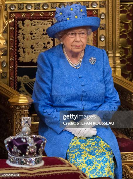 Britain's Queen Elizabeth II sits by the Imperial State Crown during the State Opening of Parliament in the Houses of Parliament in London on June...