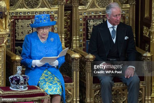 Queen Elizabeth II, accompanied by Prince Charles, Prince of Wales, makes a speech at the State Opening of Parliament in the House of Lords at the...