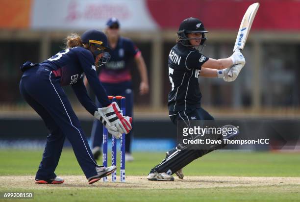 Katey Martin of New Zealand plays a shot in front of Lauren Winfield of England during the ICC Women's World Cup warm up match between England and...