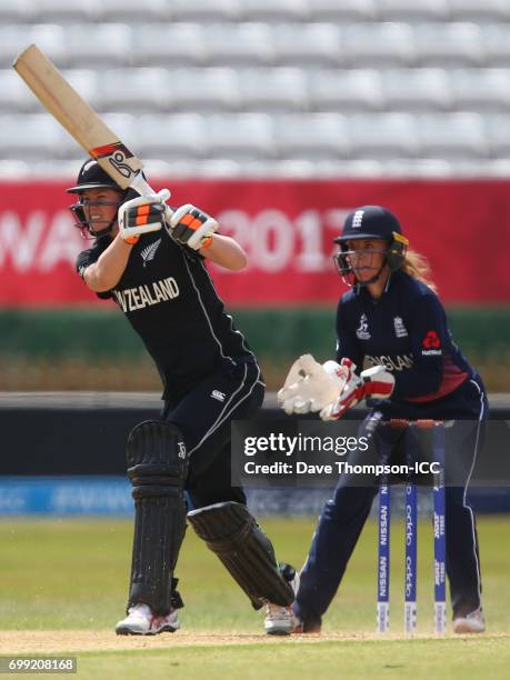 Katey Martin of New Zealand plays a shot in front of Lauren Winfield of England during the ICC Women's World Cup warm up match between England and...