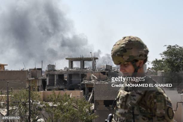 Soldier advising Iraqi forces is seen in the city of Mosul on June 21 during the ongoing offensive by Iraqi troops to retake the last district still...
