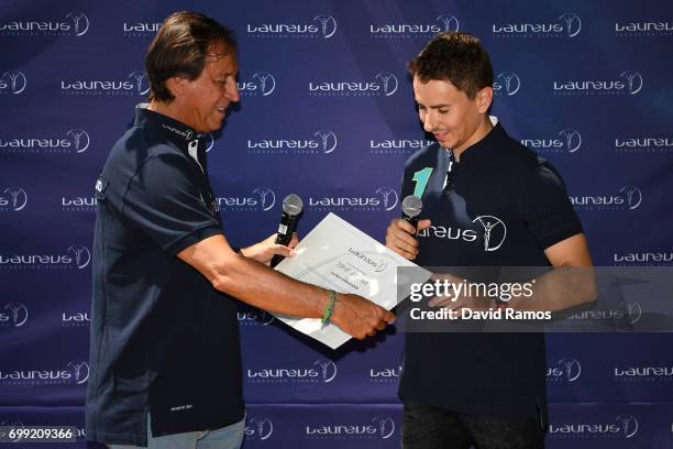 President of Laureus Spain Gabriel Masfurroll and MotoGP rider and new Laureus Ambassador Jorge Lorenzo of Spain pose for the media at the Jeroni de...